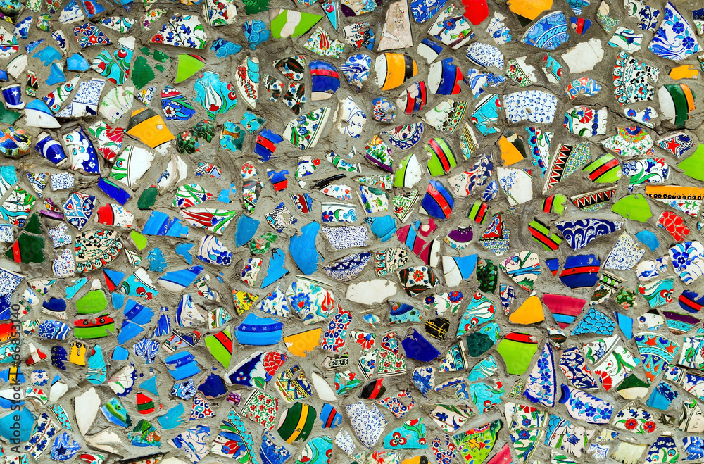 Broken ceramics dishes in wall background Broken ceramics dishes in wall background