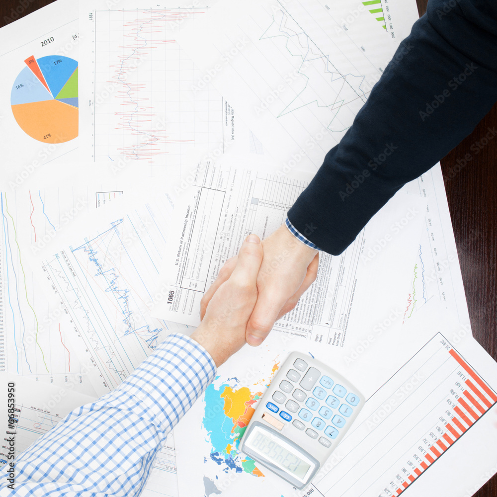 Business people shaking hands - view from top - 1 to 1 ratio Business people shaking hands - view from top - 1 to 1 ratio