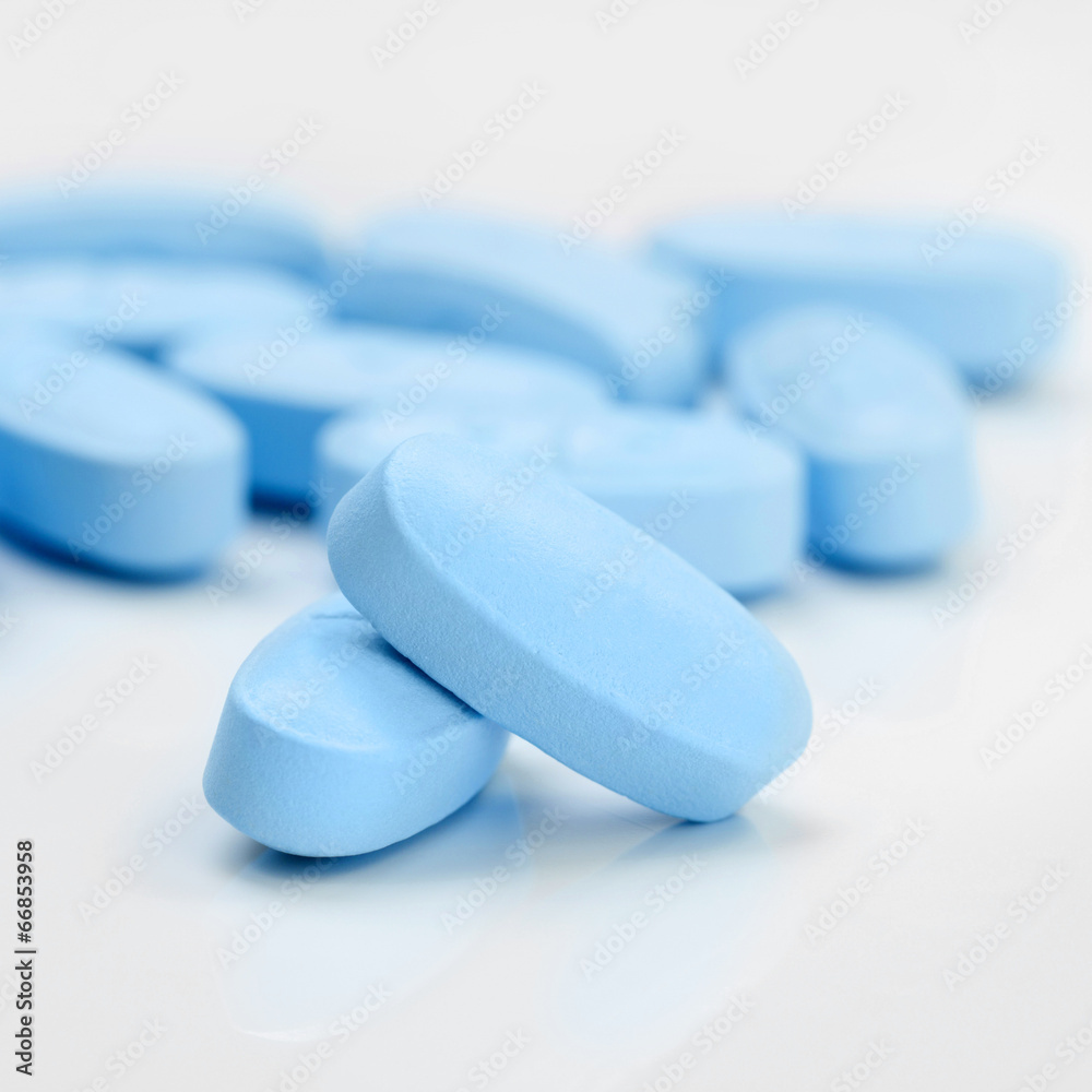 Bunch of blue pills on grey table - 1 to 1 ratio Bunch of blue pills on grey table - 1 to 1 ratio