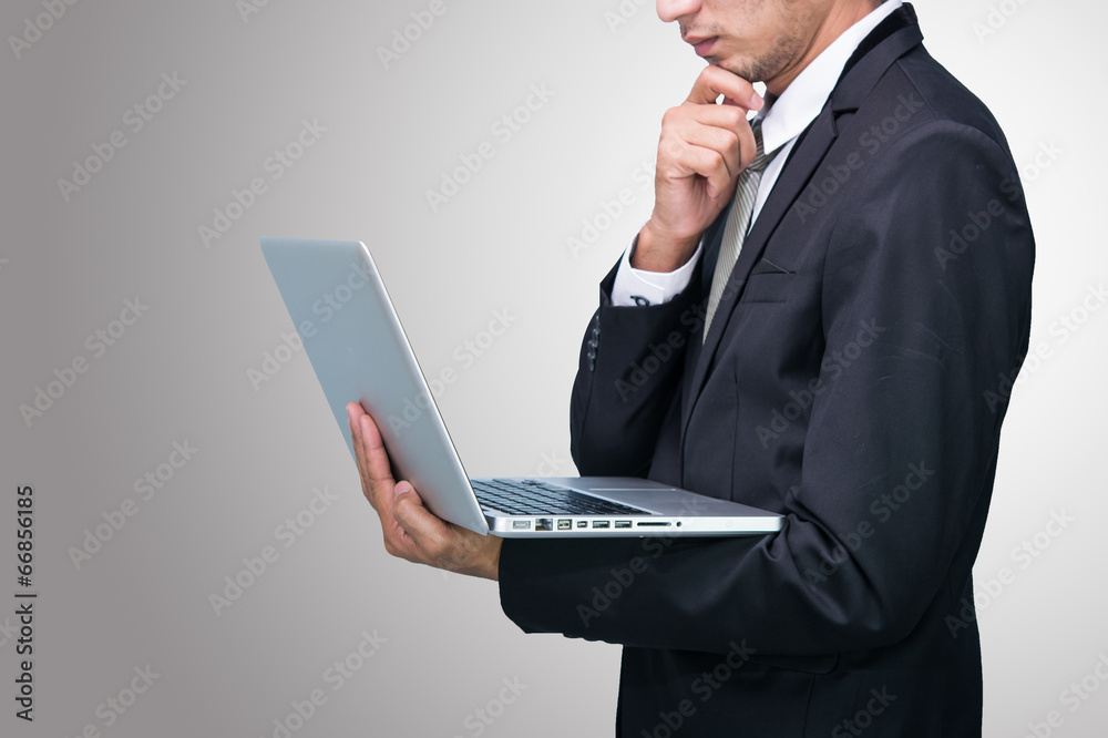 Businessman standing posture hand hold notebook laptop isolated Businessman standing posture hand hold notebook laptop isolated