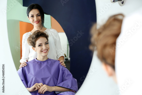 Young woman hairdresser and...