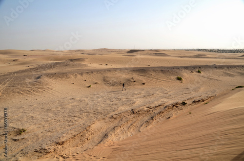 Local resident walking through the desert Dubai; UAE