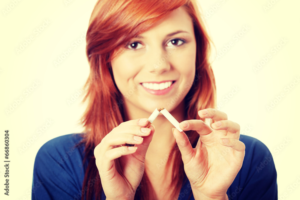 Young happy woman breaking cigarette Young happy woman breaking cigarette