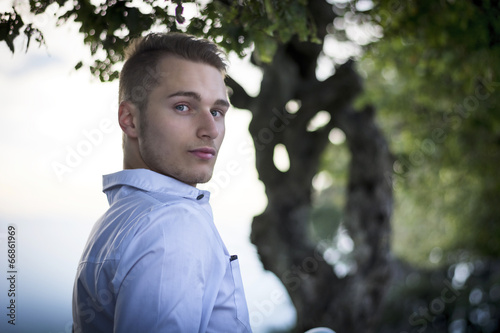 Profile shot of handsome young man outdoors