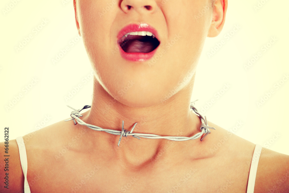Young woman with barbed wire around her throat.