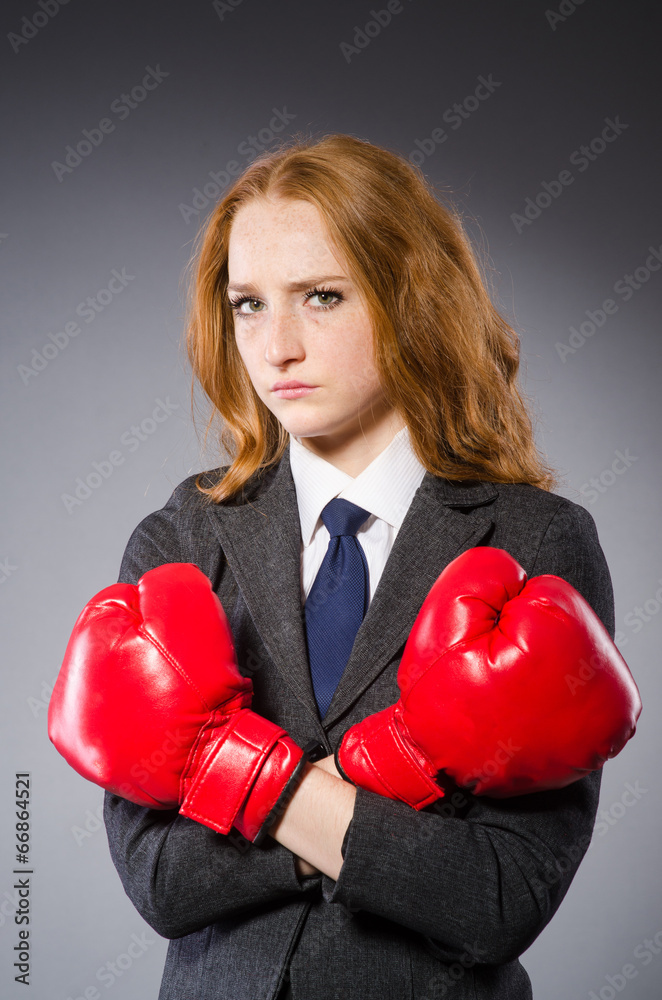 Woman boxer in dark room