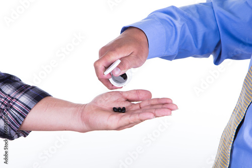 Close up of doctor hands giving a drug for patient