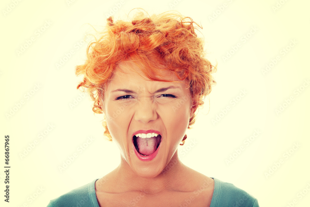 Furiouse young redhead woman screaming. Furiouse young redhead woman screaming.