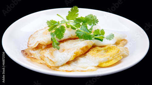 fried egg and  Parsley in the disc/isolation black background