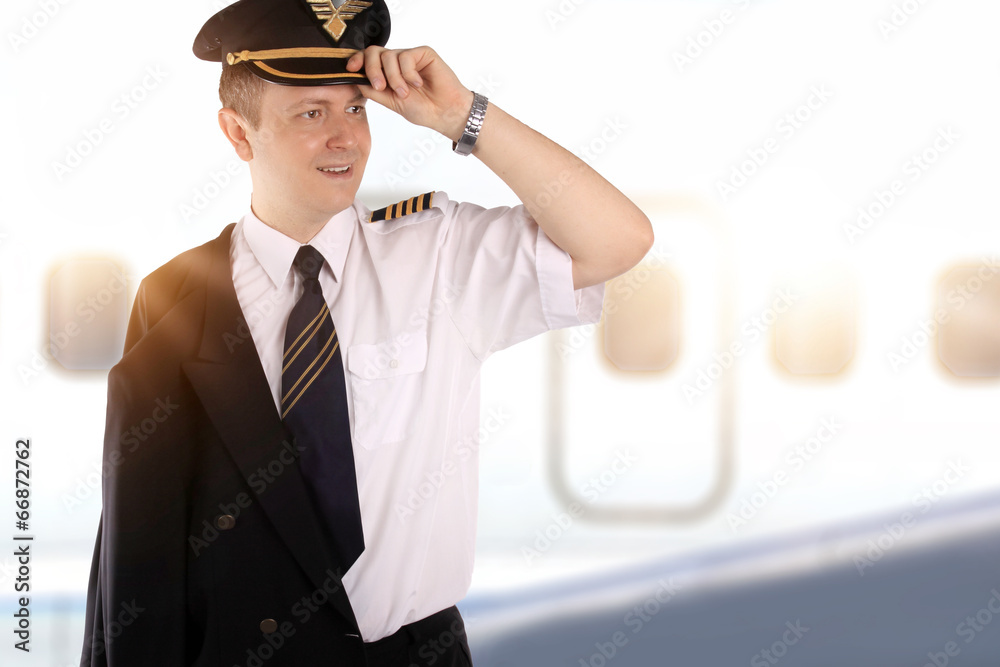 Young pilot on the background of the airplane Young pilot on the background of the airplane