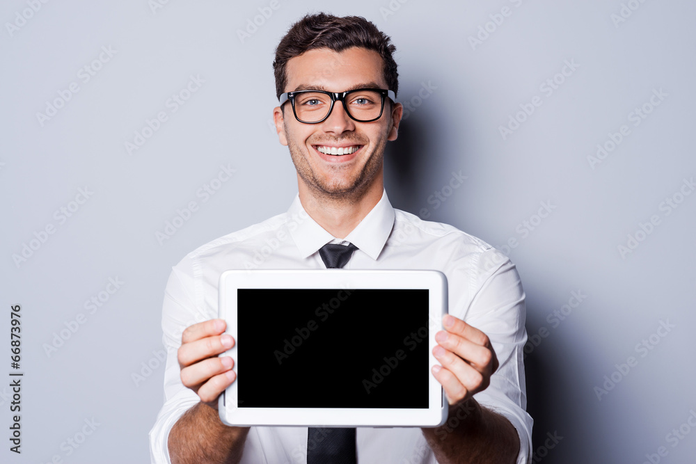 Copy space on his tablet. Copy space on his tablet.