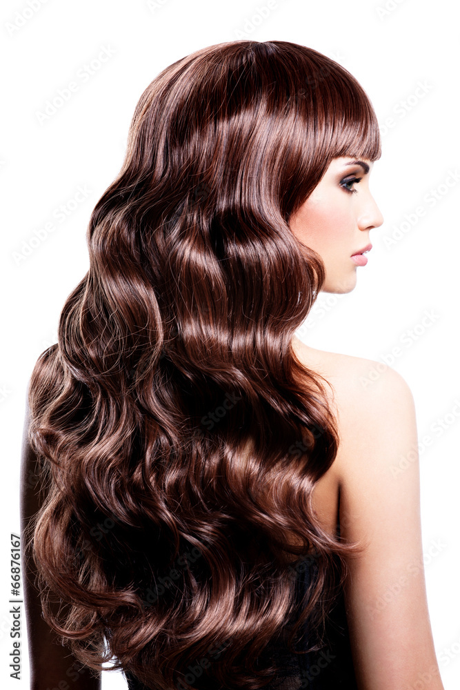 Naklejka premium Beautiful woman with brown curly hairs.