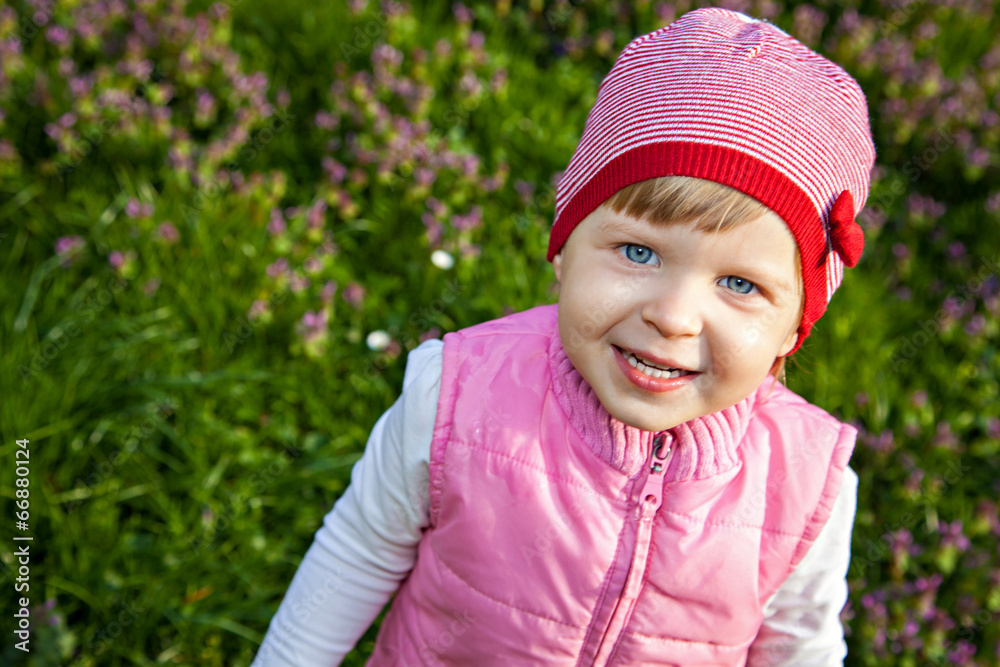 Littel girl standing in blossoming meadow Littel girl standing in blossoming meadow