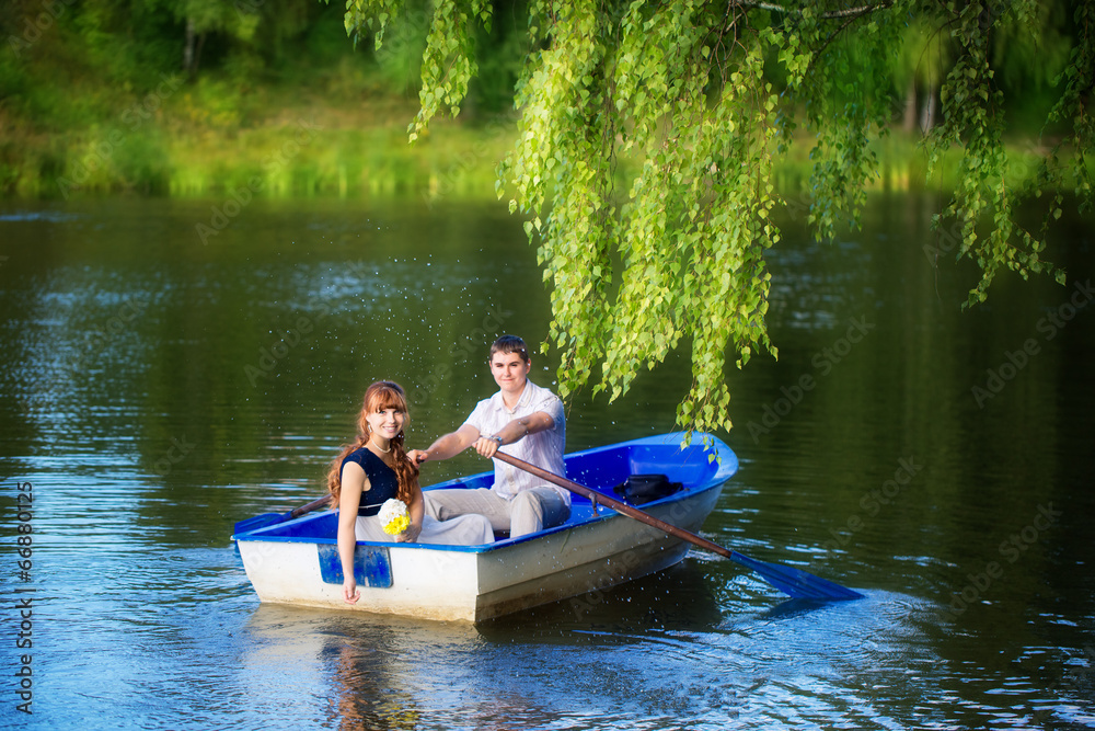 Loving couple in the boat. Summer vacation concept.