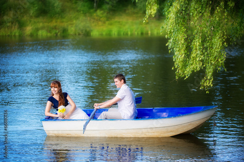 Loving couple in the boat. Summer vacation concept.