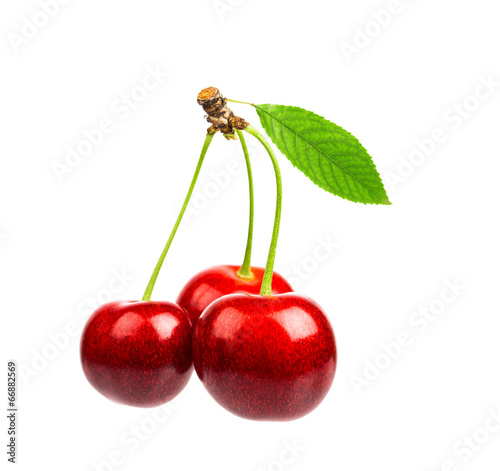 Three sweet cherries with the leaf  on a white background