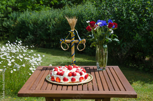 Homemade strawberry cake on decorated table in garden