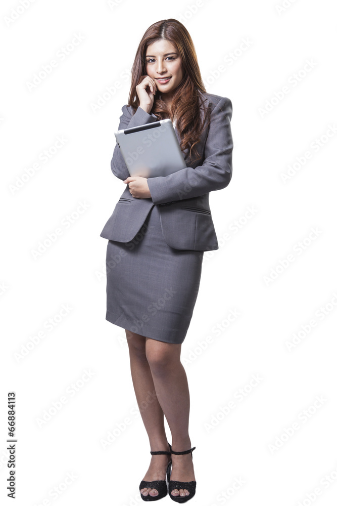 Young businesswoman standing holding digital tablet Young businesswoman standing holding digital tablet