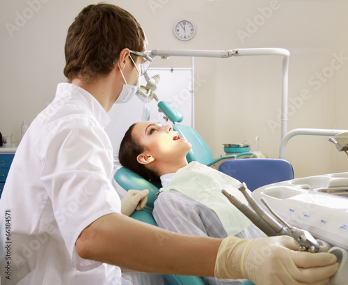 Young woman with dentist in a dental surgery. Healthcare,