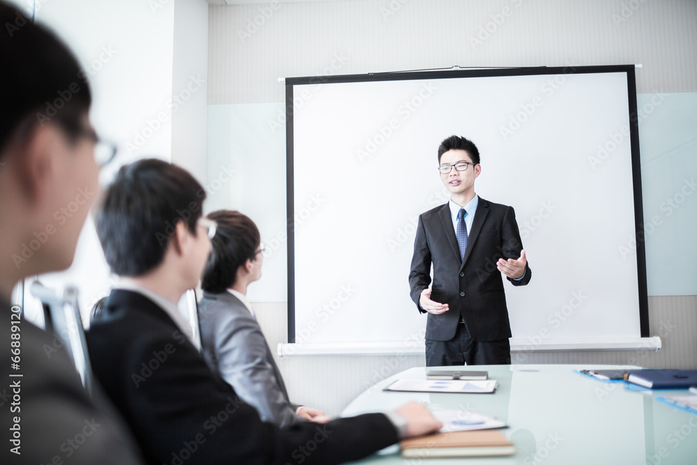 businessman giving a presentation to his colleagues businessman giving a presentation to his colleagues