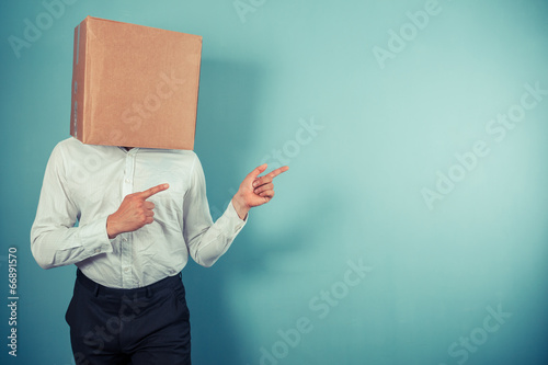 Man with box on head is pointing