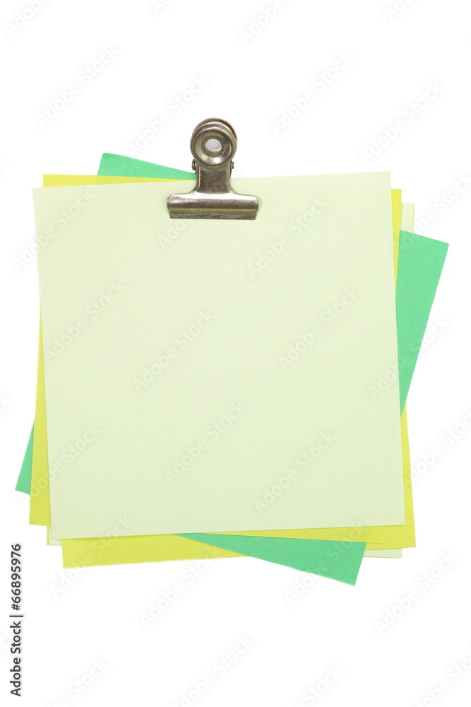 green sticker note with paper clip on white green sticker note with paper clip on white