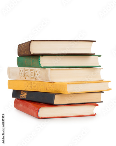 old books stacked in a pile on a white background