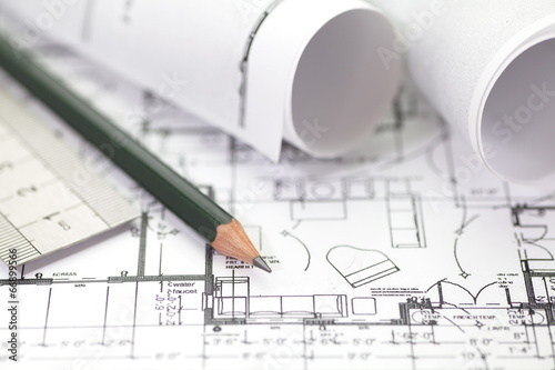 Architect rolls and plans construction project drawing