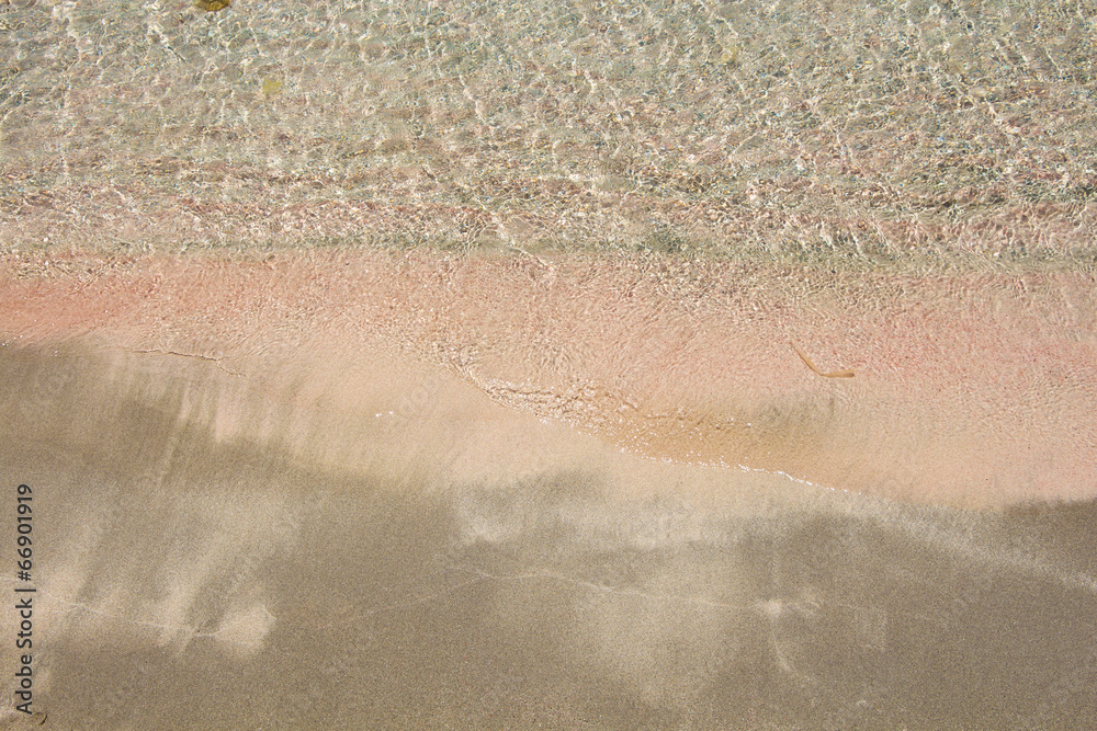 Wet fine pink sand washed by sea tide background