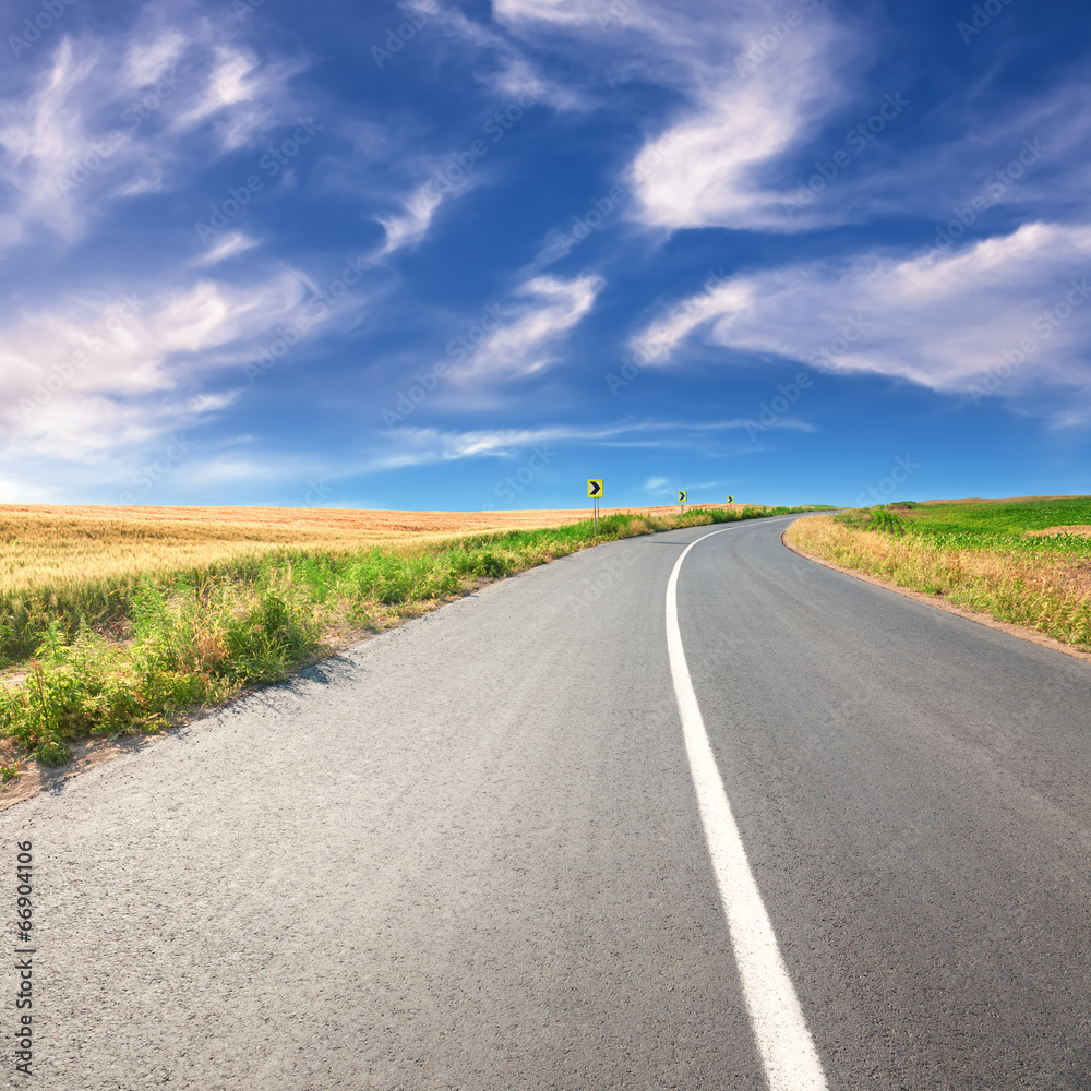 Driving on an empty asphalt road at sunny day