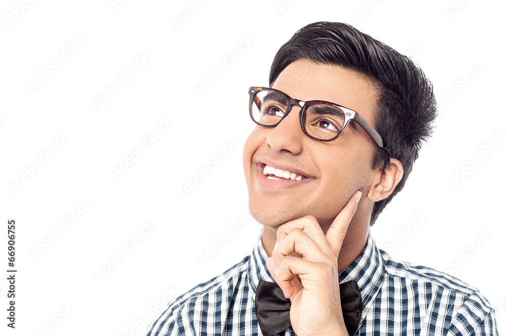 Smiling young man daydreams and looks up Smiling young man daydreams and looks up