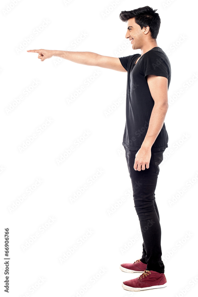 Casual young man pointing to his side Casual young man pointing to his side