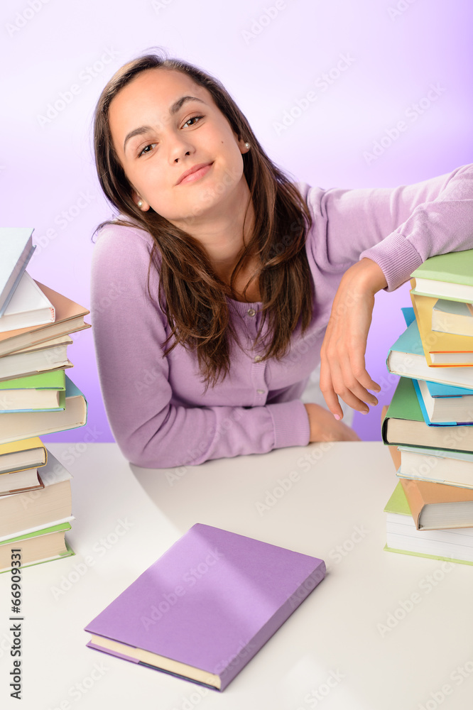 Confident student girl between stacks of books Confident student girl between stacks of books
