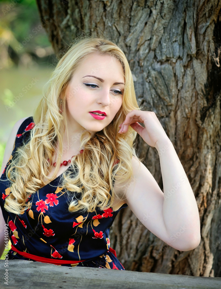 Naklejka premium Young charming woman on the nature