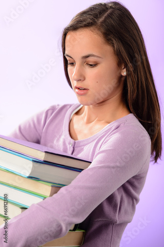 Student girl carry stack of books purple