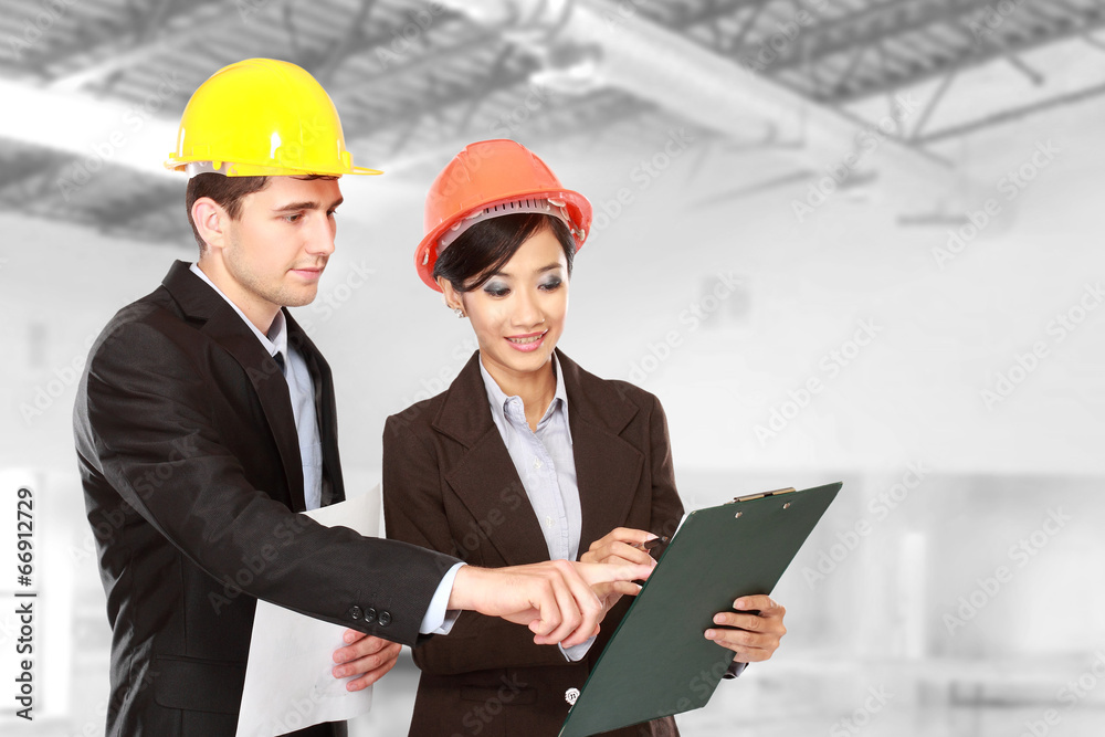 male and female architect at construction site male and female architect at construction site