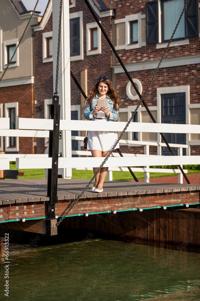 woman standing on european wooden bridge