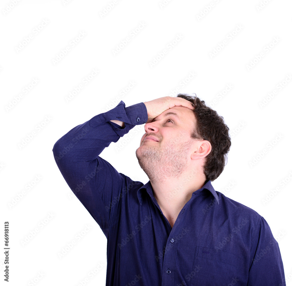 Portrait of young businessman slapping hand on head having a duh Portrait of young businessman slapping hand on head having a duh