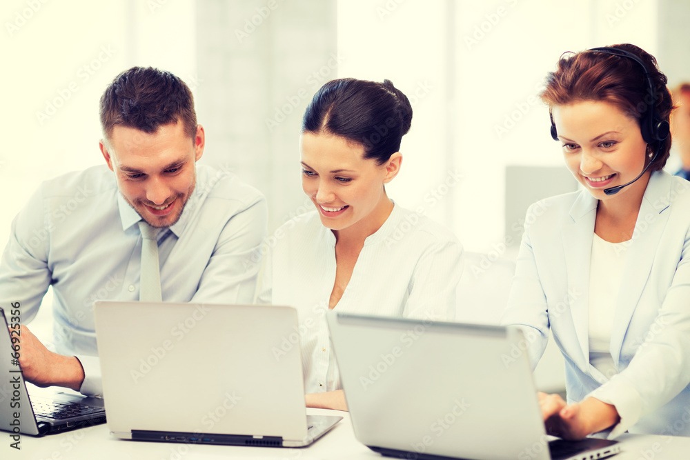 group of people working with laptops in office group of people working with laptops in office