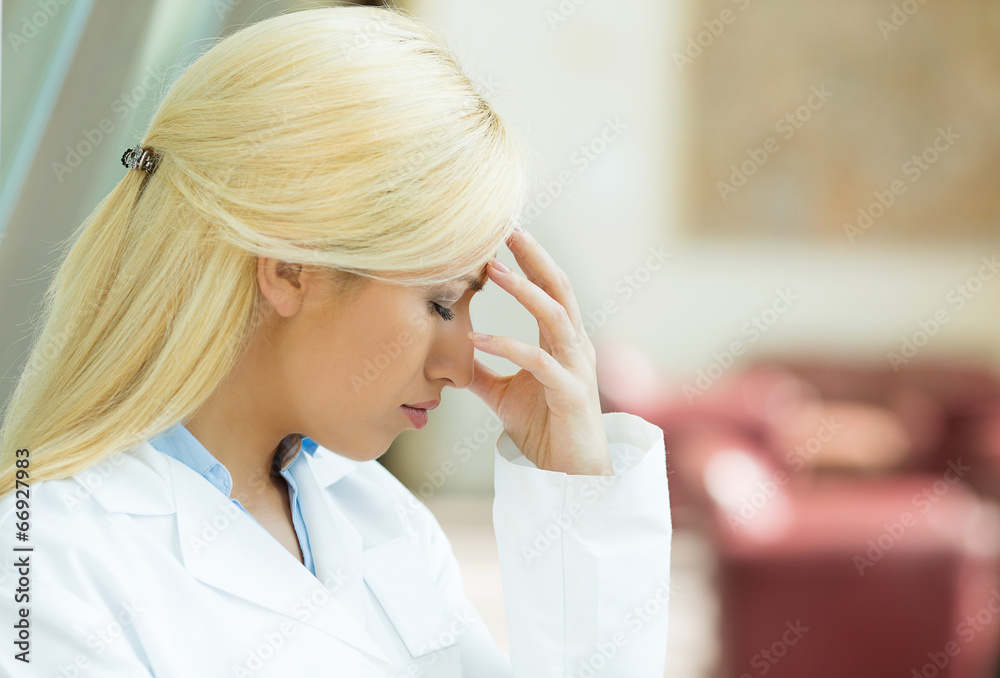 Side view closeup portrait sad stressed female doctor Side view closeup portrait sad stressed female doctor