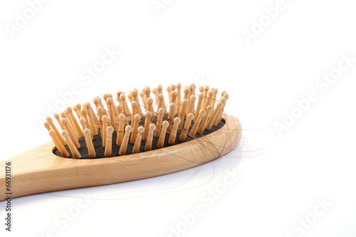 Wooden comb brush with lost hair isolated