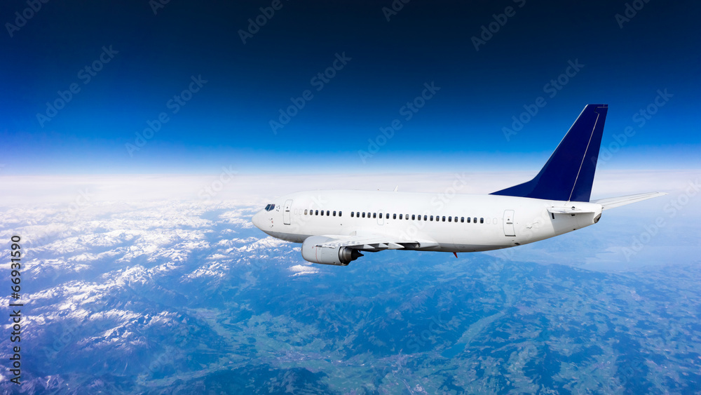 Fototapeta premium Airplane over the clouds