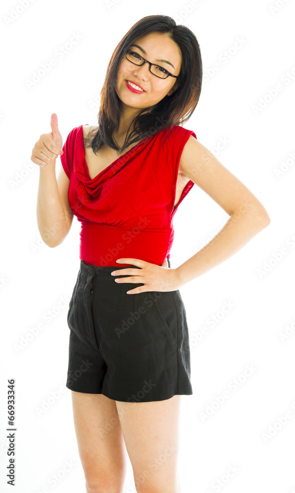 Young woman standing and showing thumbs up sign Young woman standing and showing thumbs up sign