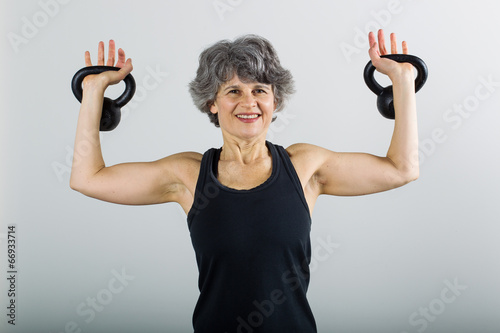 Middle Aged Female Sports Trainer With Kettle Bell