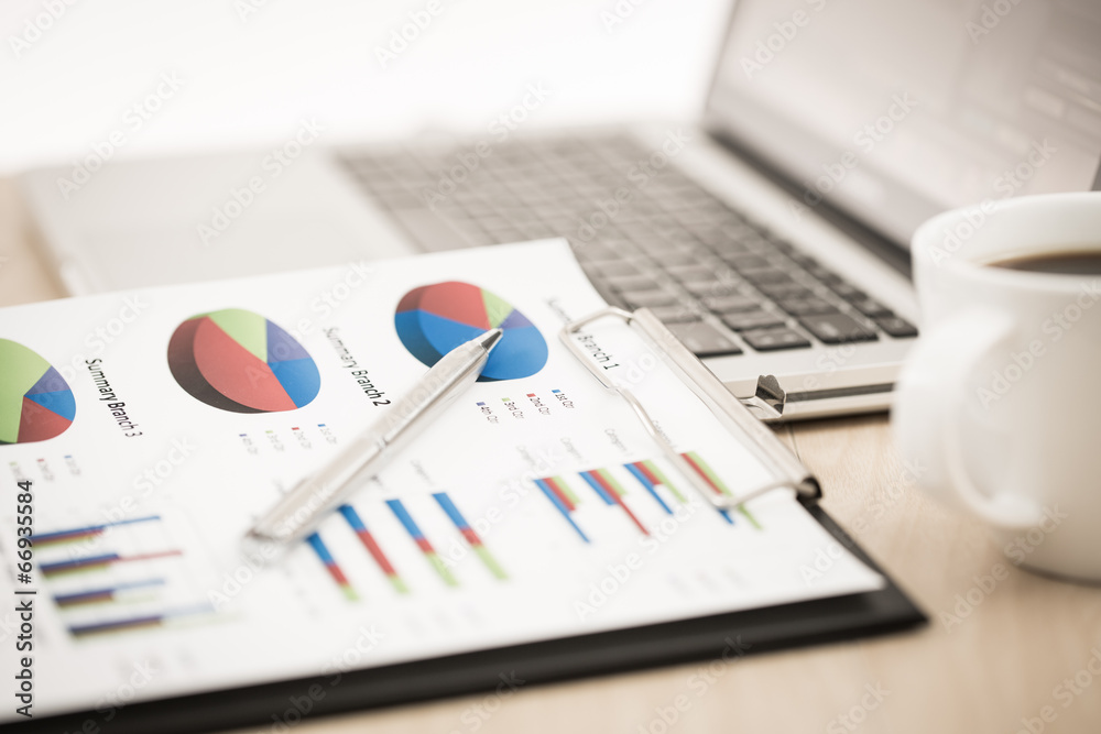 Fototapeta premium Businessman analyzing investment charts with laptop