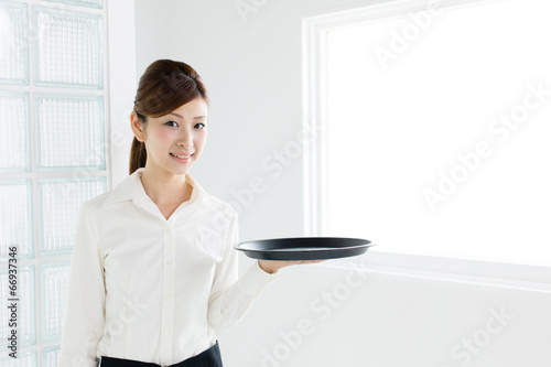 young asian waitress in white room