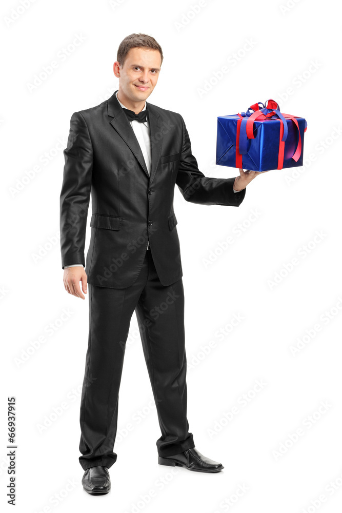 Full length portrait of an elegant man holding a present Full length portrait of an elegant man holding a present
