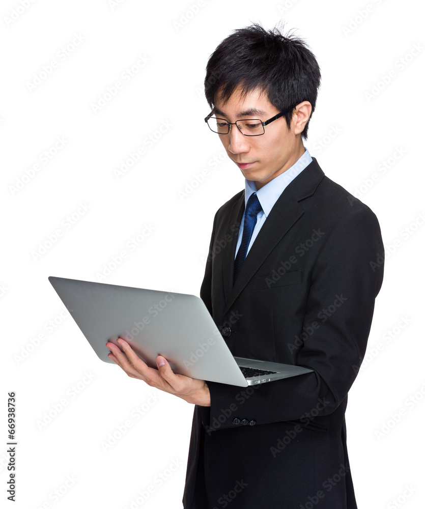 Businessman look at laptop computer Businessman look at laptop computer