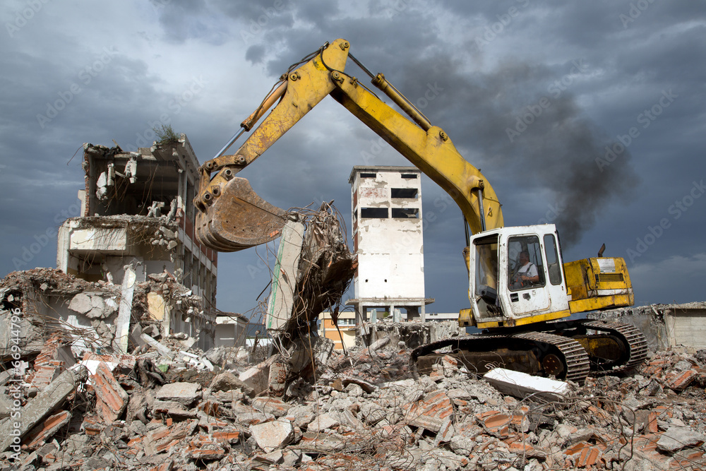 Bulldozer removes the debris from demolition of old buildings Bulldozer removes the debris from demolition of old buildings