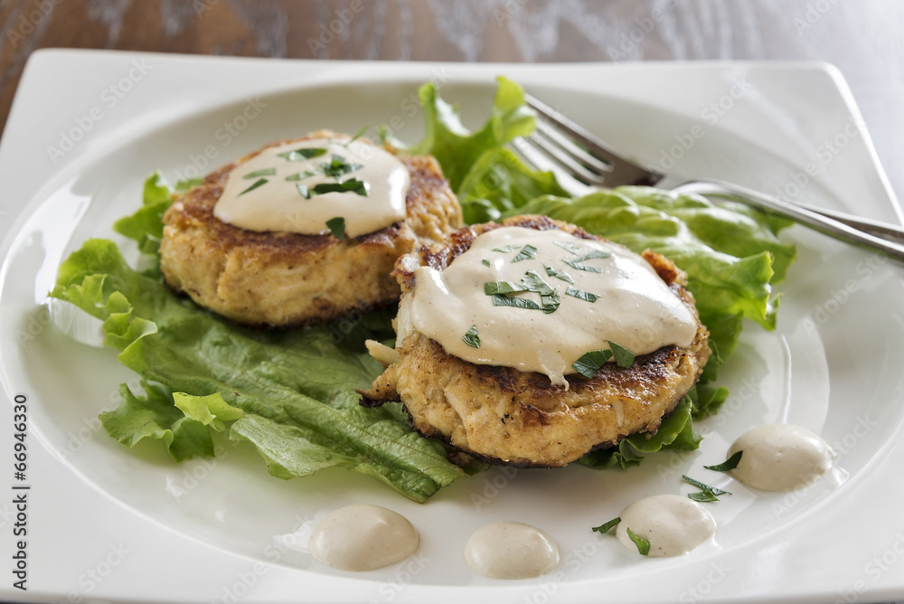 Crab cakes with a creamy mustard sauce and fresh parsley Crab cakes with a creamy mustard sauce and fresh parsley